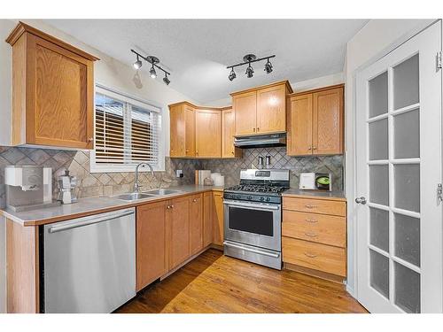 29 Crystal Shores Crescent, Okotoks, AB - Indoor Photo Showing Kitchen With Double Sink