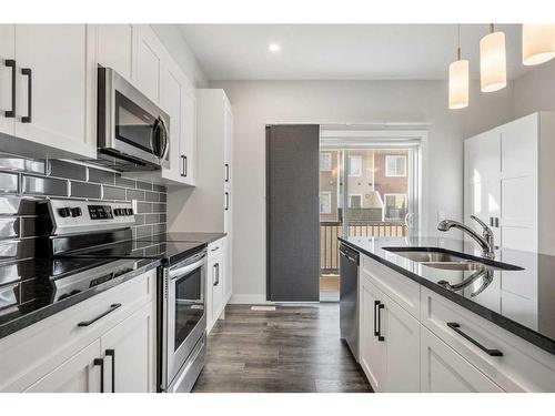 484 Canals Crossing Sw, Airdrie, AB - Indoor Photo Showing Kitchen With Stainless Steel Kitchen With Double Sink With Upgraded Kitchen