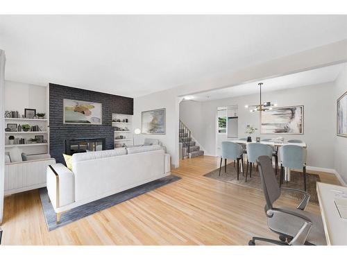 104-9803 24 Street Sw, Calgary, AB - Indoor Photo Showing Living Room With Fireplace