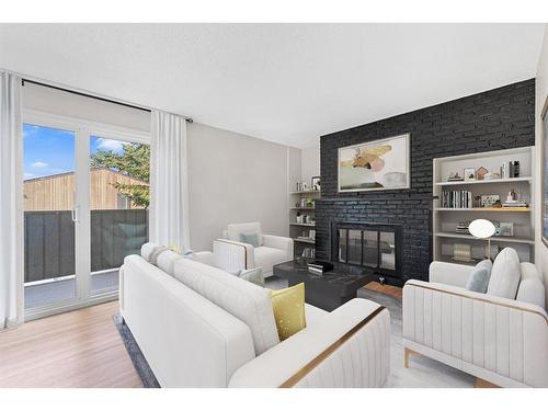 104-9803 24 Street Sw, Calgary, AB - Indoor Photo Showing Living Room With Fireplace