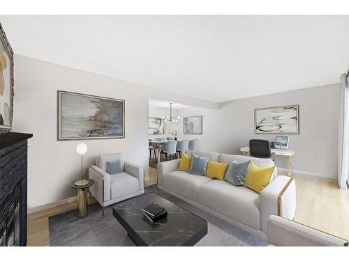 104-9803 24 Street Sw, Calgary, AB - Indoor Photo Showing Living Room With Fireplace