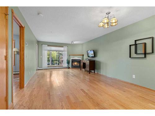 213-728 Country Hills Road Nw, Calgary, AB - Indoor Photo Showing Living Room With Fireplace