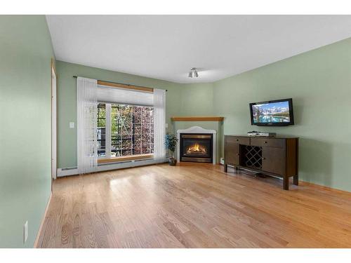 213-728 Country Hills Road Nw, Calgary, AB - Indoor Photo Showing Living Room With Fireplace