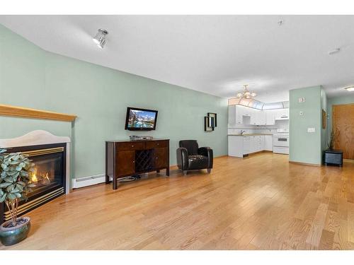 213-728 Country Hills Road Nw, Calgary, AB - Indoor Photo Showing Living Room With Fireplace