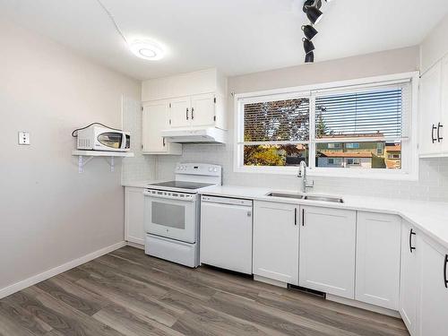 403-5660 23 Avenue Ne, Calgary, AB - Indoor Photo Showing Kitchen With Double Sink