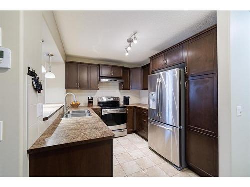 3049 Windsong Boulevard Sw, Airdrie, AB - Indoor Photo Showing Kitchen With Stainless Steel Kitchen With Double Sink