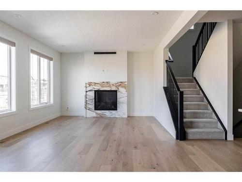 243 Marina Grove Se, Calgary, AB - Indoor Photo Showing Living Room With Fireplace