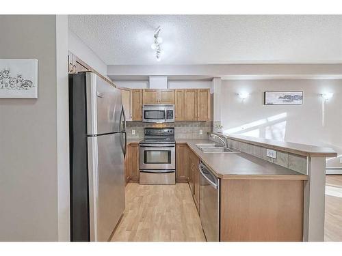 2101-211 Aspen Stone Boulevard Sw, Calgary, AB - Indoor Photo Showing Kitchen With Stainless Steel Kitchen