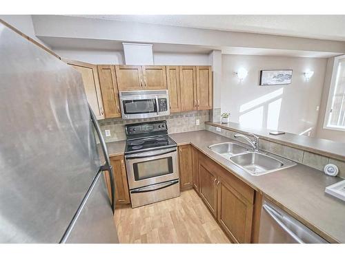 2101-211 Aspen Stone Boulevard Sw, Calgary, AB - Indoor Photo Showing Kitchen With Double Sink