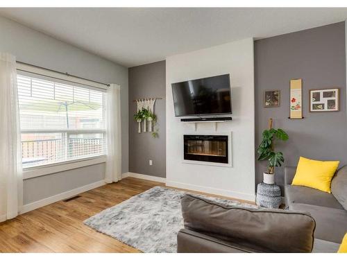 15 Baysprings Way Sw, Airdrie, AB - Indoor Photo Showing Living Room With Fireplace