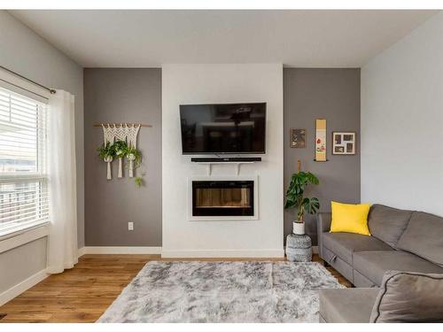 15 Baysprings Way Sw, Airdrie, AB - Indoor Photo Showing Living Room With Fireplace