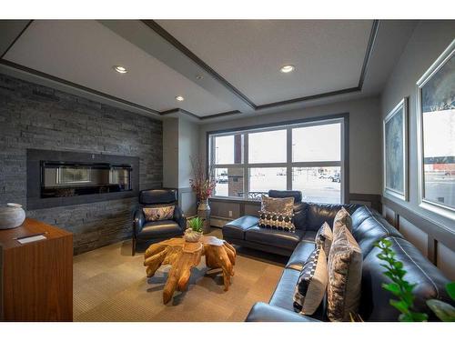 2407-10 Market Boulevard Se, Airdrie, AB - Indoor Photo Showing Living Room With Fireplace