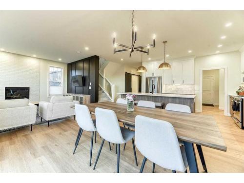 15 Bearberry Lane, Okotoks, AB - Indoor Photo Showing Dining Room With Fireplace