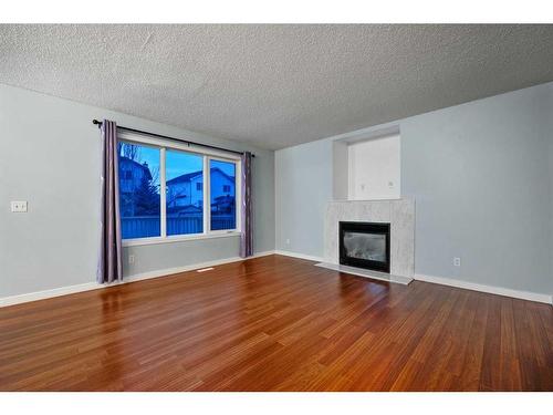 78 Evansmeade Circle Nw, Calgary, AB - Indoor Photo Showing Living Room With Fireplace