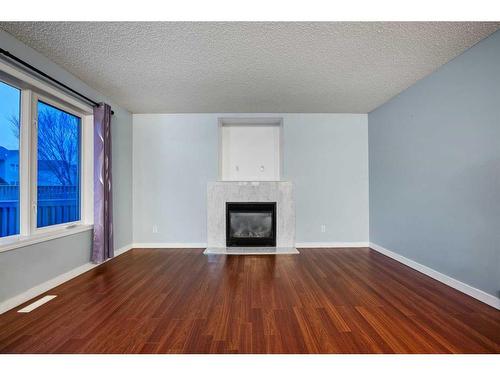 78 Evansmeade Circle Nw, Calgary, AB - Indoor Photo Showing Living Room With Fireplace