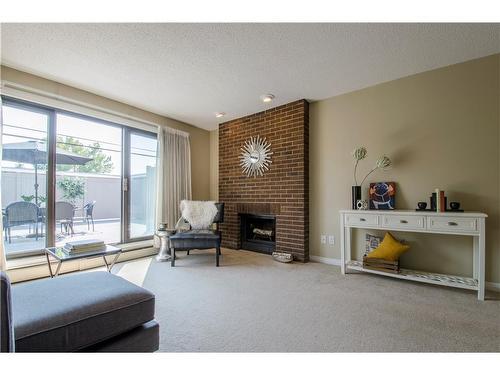 202-611 67 Avenue Sw, Calgary, AB - Indoor Photo Showing Living Room With Fireplace