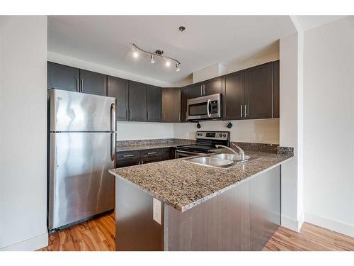 Suite 420-955 Mcpherson Road Ne, Calgary, AB - Indoor Photo Showing Kitchen With Stainless Steel Kitchen With Double Sink With Upgraded Kitchen