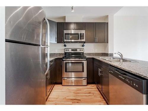 Suite 420-955 Mcpherson Road Ne, Calgary, AB - Indoor Photo Showing Kitchen With Stainless Steel Kitchen With Double Sink