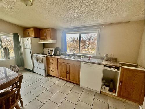 2303 23 Street, Nanton, AB - Indoor Photo Showing Kitchen With Double Sink