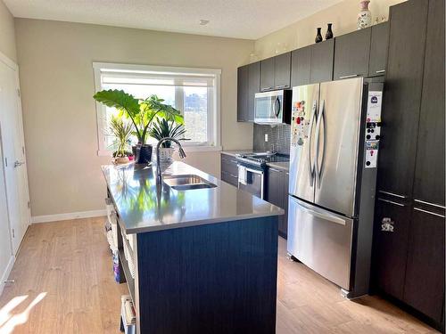 407-218 Sherwood Square Nw, Calgary, AB - Indoor Photo Showing Kitchen With Stainless Steel Kitchen With Double Sink