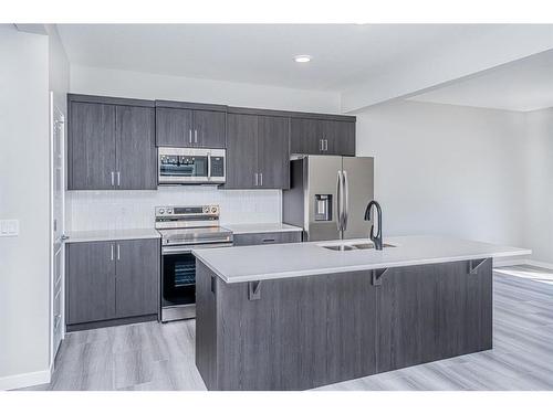 600 Baywater Manor Sw, Airdrie, AB - Indoor Photo Showing Kitchen With Double Sink With Upgraded Kitchen