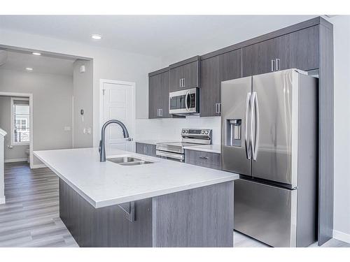 600 Baywater Manor Sw, Airdrie, AB - Indoor Photo Showing Kitchen With Double Sink With Upgraded Kitchen