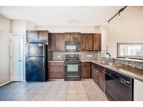 1204-125 Panatella Way Nw, Calgary, AB - Indoor Photo Showing Kitchen With Double Sink