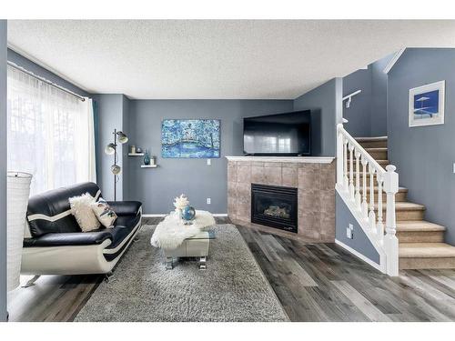 16 Cramond Drive Se, Calgary, AB - Indoor Photo Showing Living Room With Fireplace