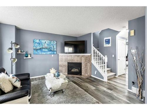 16 Cramond Drive Se, Calgary, AB - Indoor Photo Showing Living Room With Fireplace