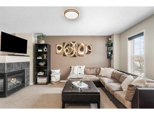 42 Silverado Plains Manor Sw, Calgary, AB - Indoor Photo Showing Living Room With Fireplace