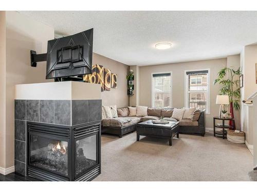 42 Silverado Plains Manor Sw, Calgary, AB - Indoor Photo Showing Living Room With Fireplace