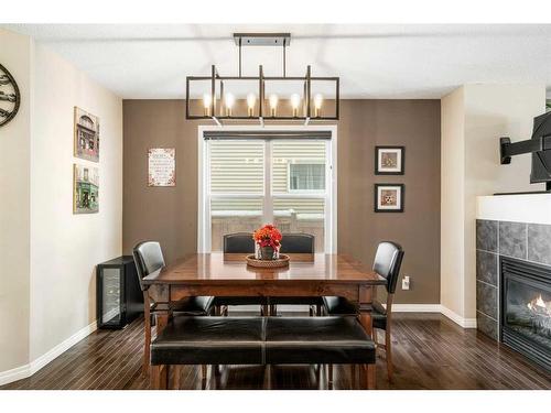 42 Silverado Plains Manor Sw, Calgary, AB - Indoor Photo Showing Dining Room With Fireplace