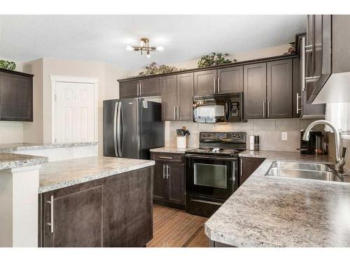 42 Silverado Plains Manor Sw, Calgary, AB - Indoor Photo Showing Kitchen With Double Sink