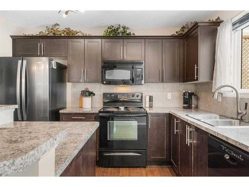 42 Silverado Plains Manor Sw, Calgary, AB - Indoor Photo Showing Kitchen With Double Sink