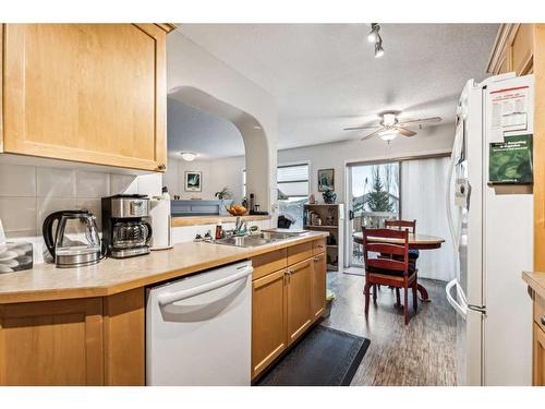 11-117 Bow Ridge Drive, Cochrane, AB - Indoor Photo Showing Kitchen With Double Sink