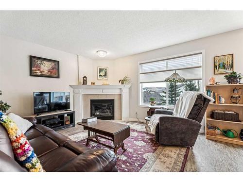 11-117 Bow Ridge Drive, Cochrane, AB - Indoor Photo Showing Living Room With Fireplace