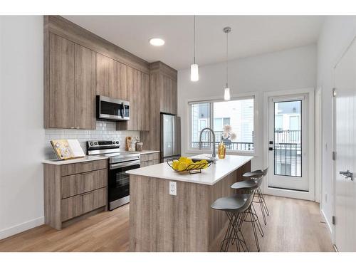 502-101 Panatella Square Nw, Calgary, AB - Indoor Photo Showing Kitchen With Stainless Steel Kitchen With Upgraded Kitchen