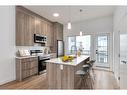 502-101 Panatella Square Nw, Calgary, AB  - Indoor Photo Showing Kitchen With Stainless Steel Kitchen With Upgraded Kitchen 