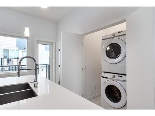 502-101 Panatella Square Nw, Calgary, AB - Indoor Photo Showing Laundry Room