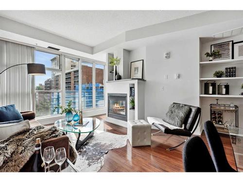 606-205 Riverfront Avenue Sw, Calgary, AB - Indoor Photo Showing Living Room With Fireplace