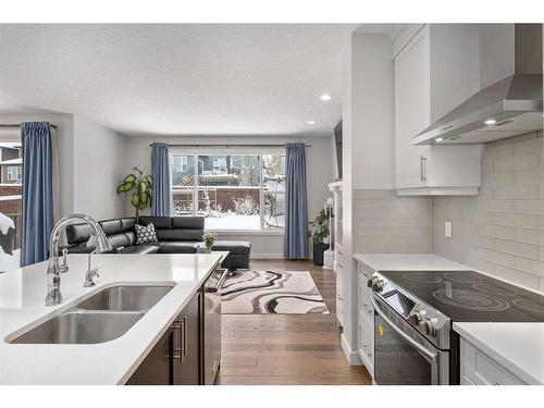 100 Cranbrook Way Se, Calgary, AB - Indoor Photo Showing Kitchen With Stainless Steel Kitchen With Double Sink With Upgraded Kitchen