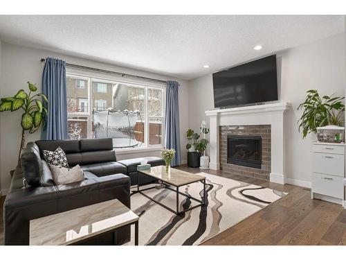 100 Cranbrook Way Se, Calgary, AB - Indoor Photo Showing Living Room With Fireplace