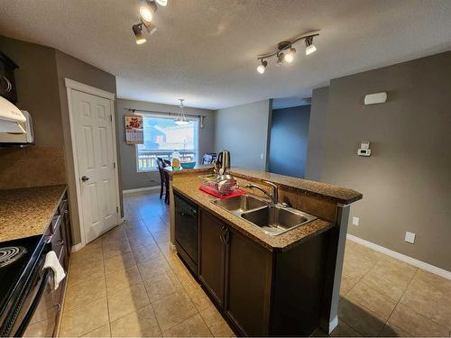 1061 Panatella Boulevard Nw, Calgary, AB - Indoor Photo Showing Kitchen With Double Sink