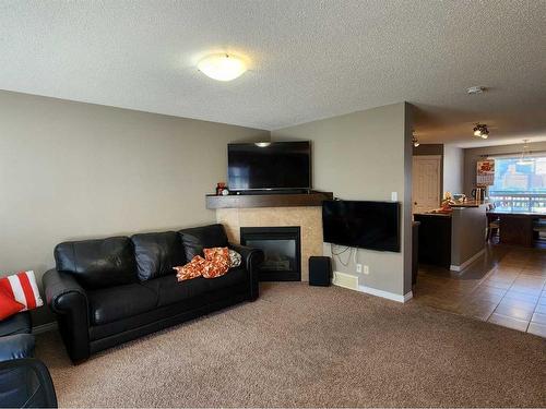 1061 Panatella Boulevard Nw, Calgary, AB - Indoor Photo Showing Living Room With Fireplace