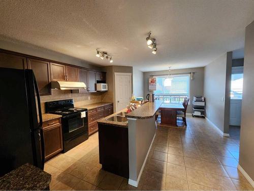 1061 Panatella Boulevard Nw, Calgary, AB - Indoor Photo Showing Kitchen With Double Sink