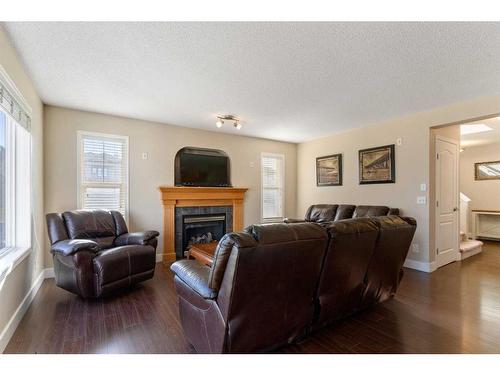 244 Hawkmere View, Chestermere, AB - Indoor Photo Showing Living Room With Fireplace