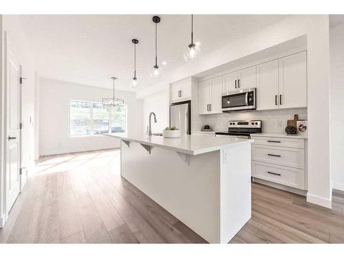 905-525 River Heights Drive, Cochrane, AB - Indoor Photo Showing Kitchen With Stainless Steel Kitchen With Upgraded Kitchen