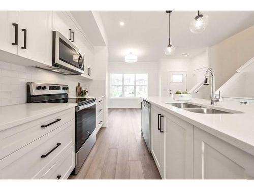 905-525 River Heights Drive, Cochrane, AB - Indoor Photo Showing Kitchen With Double Sink With Upgraded Kitchen