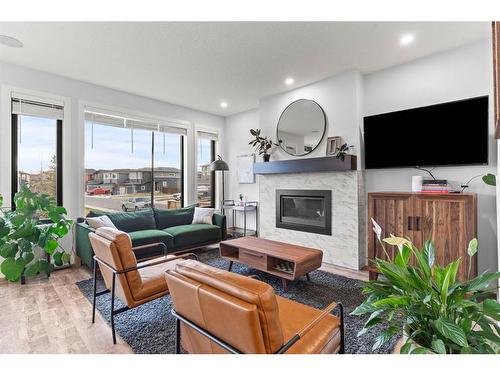 61 Creekstone Square Sw, Calgary, AB - Indoor Photo Showing Living Room With Fireplace