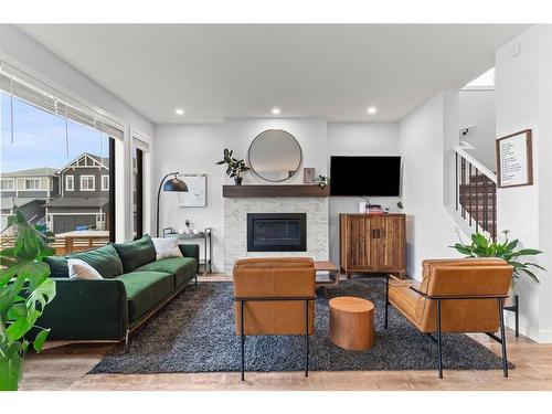 61 Creekstone Square Sw, Calgary, AB - Indoor Photo Showing Living Room With Fireplace